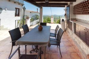 a table and chairs on a patio with a view at El Balcón de La Safor - Llumicel in Ador