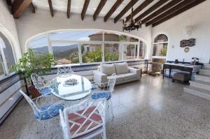 a living room with a table and chairs and a couch at El Balcón de La Safor - Llumicel in Ador