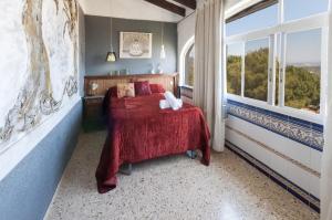 a bedroom with a bed and a large window at El Balcón de La Safor - Llumicel in Ador +25 photos