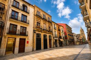 an empty street in an old town with buildings at Rua Mayor MSuites in Salamanca