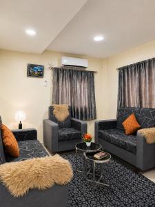 a living room with two couches and a table at Nadi Holiday House in Nadi