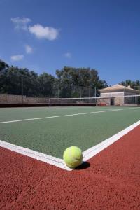 a tennis ball sitting on a tennis court at MIRA Resort Maizonettes in Lefkada
