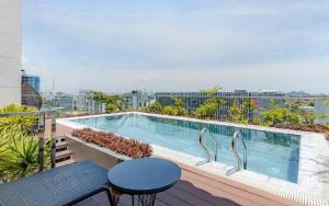 a swimming pool on the balcony of a building at Seasol Beach Boutique hotel in Danang