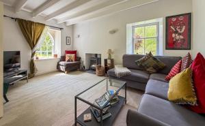 a living room with a couch and a table at Foresters Cottage, Dalry in Dalry