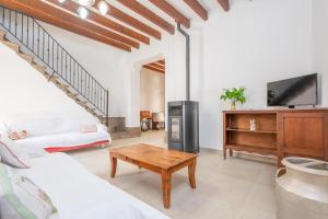 a living room with a couch and a table at Can Romaguera in Algaida