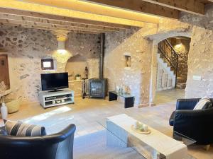 a living room with a tv and a fireplace at Can Pina - Eco Pina - in Costitx