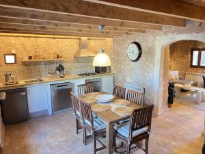 a kitchen and dining room with a table and chairs at Can Pina - Eco Pina - in Costitx