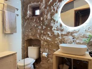 a bathroom with a sink and a toilet and a mirror at Can Pina - Eco Pina - in Costitx +29 photos