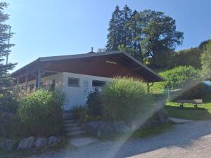 a small house with a red roof and stairs at Luxus Wohnwagen Alpenblick in Weiler-Simmerberg +34 photos