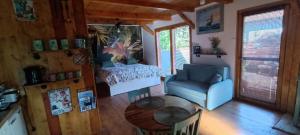 a room with a bed and a table and a chair at Kajüt Apartman in Balatonfenyves