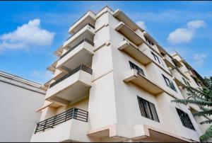 a building with balconies on the side of it at Hotel Pratishtha in Guwahati