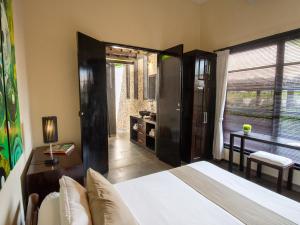 a bedroom with a large bed and a bathroom at Villa Bossi Bali at Tanguwesia in Bubunan +49 photos