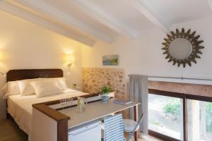 a bedroom with a bed and a desk with a mirror at Finca Son Vidal in Llucmajor +26 photos