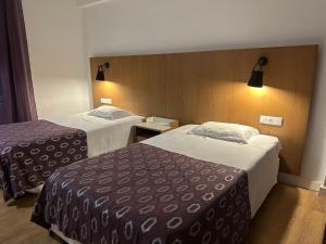 a hotel room with two beds in a room at Hotel Brasa in Elvas