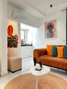 a living room with a couch and a table at Dyden luxury appartement in Douala