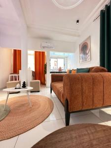 a living room with a couch and a table at Dyden luxury appartement in Douala