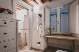 a bathroom with a sink and a window at Bargello House by FrancigenaApartments in Siena +30 photos