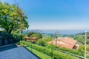 a view of the ocean from the balcony of a house at Le Relais du Lierre - Conero Nature Retreat in Poggio +203 photos