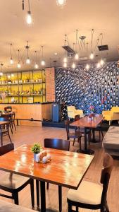 a restaurant with tables and chairs and a wine cellar at Bricks Hotel in Tbilisi City