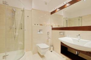 a bathroom with a sink and a toilet and a shower at Hotel Lubicz in Ustka +43 photos