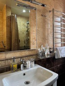 a bathroom with a sink and a mirror at Hotel DALIM in Duliby +37 photos