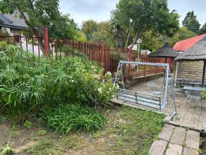 a garden with a metal gate in a yard at Bella - Rosa in Ficksburg +6 photos