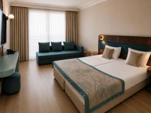 a hotel room with a large bed and a couch at Kristal Hotel - All inclusive - Fully renovated in Golden Sands