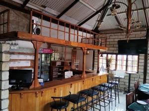a bar in a restaurant with chairs and tables at Bella - Rosa in Ficksburg