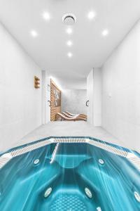 a house with a swimming pool in a room at Hotel Sněžka in Špindlerův Mlýn