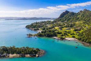 an aerial view of the islands in the water at Reotahi Bolthole in Whangarei Heads