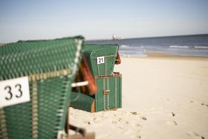 a group of beach chairs sitting on the beach at Appartement 06 Strandvillen Wald & See in Zinnowitz +3 photos