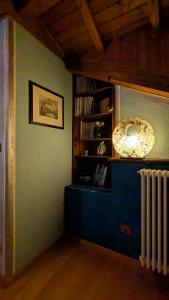 a room with a book shelf and a radiator at Chambres d'Hotes Quart de Lune in Quart
