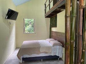 a bedroom with a bed and a television in it at Casa Sankofa de Belém in Belém