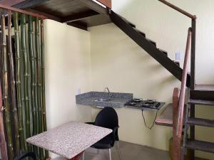 a kitchen with a sink and a table and a stairs at Casa Sankofa de Belém in Belém +48 photos