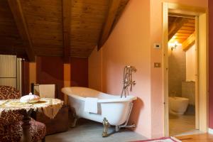 a bathroom with a bath tub and a sink at Chambres d'Hotes Quart de Lune in Quart +29 photos