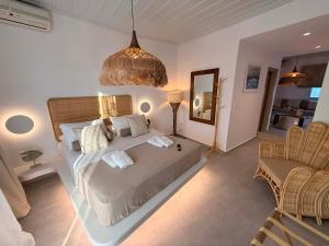 a bedroom with a bed and a table and chairs at Kohylia Beach Guest House in Platis Gialos