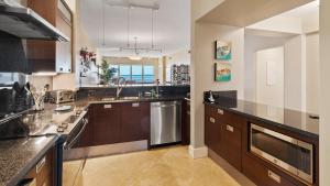 a large kitchen with brown cabinets and stainless steel appliances at 334 Mariners Club in Key Largo
