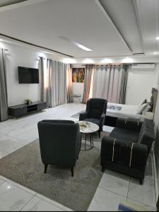 a large living room with a couch and chairs at Hotel liberté 6 in Dakar