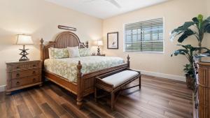 a bedroom with a wooden bed and a dresser and a window at 334 Mariners Club in Key Largo +44 photos