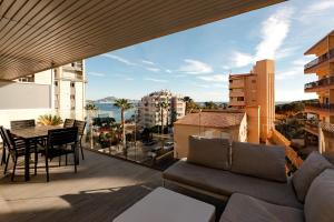a balcony with a couch and a table with a view at Superior Calpe Pearl Beach in Calpe
