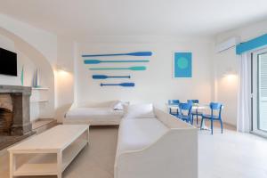a living room with a couch and a table and chairs at Residence Le Terrazze in Sorrento