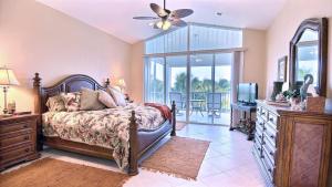 a bedroom with a bed with a dresser and a television at 403 Mariners Club in Key Largo +40 photos