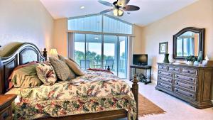 a bedroom with a bed and a dresser and a mirror at 403 Mariners Club in Key Largo
