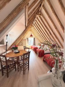 a attic room with a table and a bed at Hotel - Cafe De Harmonie in Edam