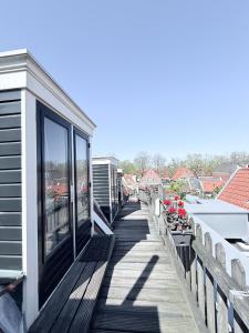 a wooden deck with a view of a marina at Hotel - Cafe De Harmonie in Edam
