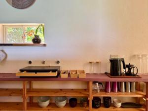 a kitchen with a counter with a coffee maker on it at Green Rabbit House by private beach in Ishigaki Island