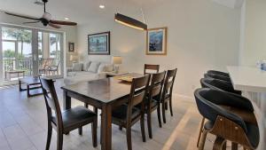 a dining room and living room with a table and chairs at 406 Mariners Club in Key Largo