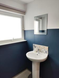 a bathroom with a white sink and a window at Kindrogan House in Straloch +39 photos