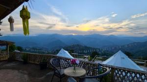 a balcony with a table and a view of mountains at Infinite horizon nan in Ban San Khet Yao +16 photos