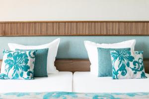 two beds with blue and white pillows in a bedroom at Kristal Hotel - All inclusive - Fully renovated in Golden Sands +108 photos